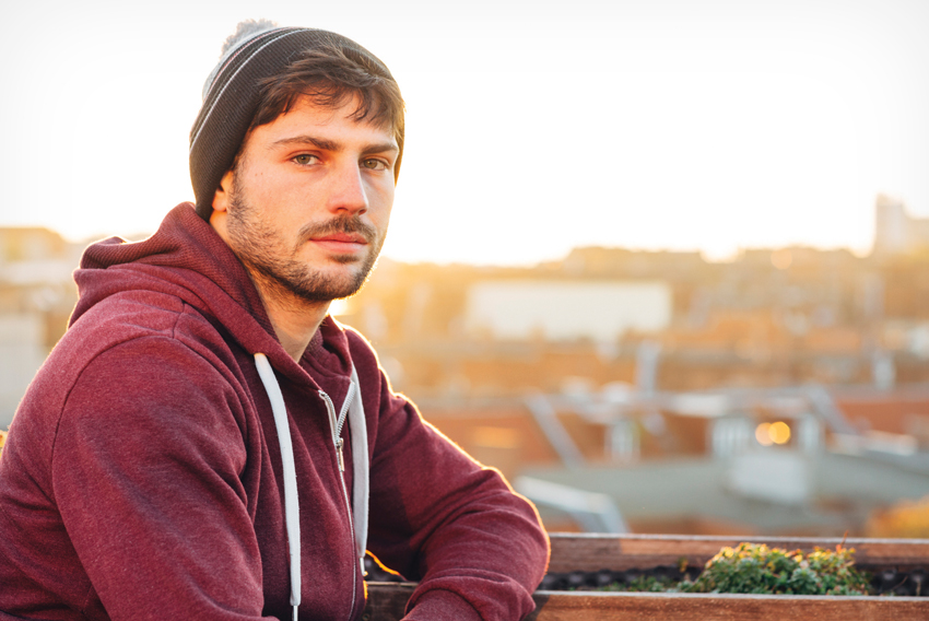 Stock photo of young man against an urban backdrop