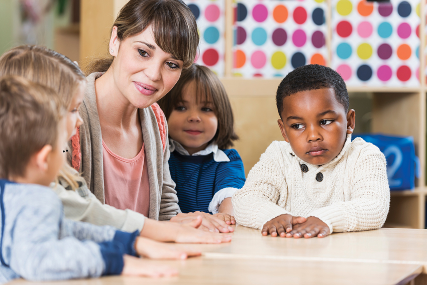 Stock photo of woman with children in classroom