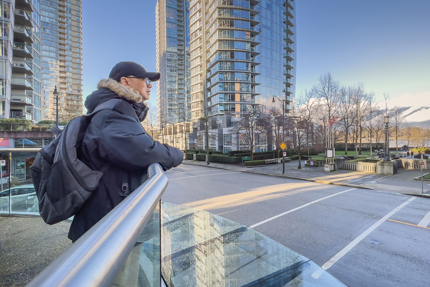 Stock photo of man leaning against a balustrade