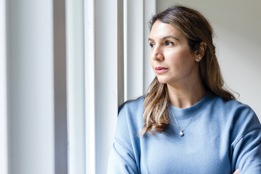 Stock photo of woman looking out a window