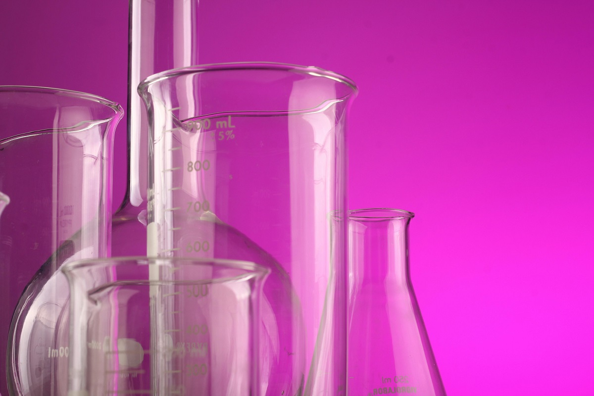 image of chemistry glassware against a purple background