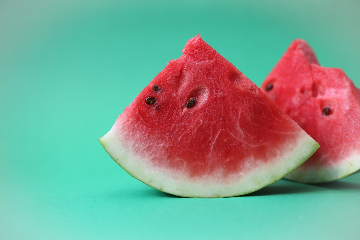 stock photo of a watermelon slice on a green background
