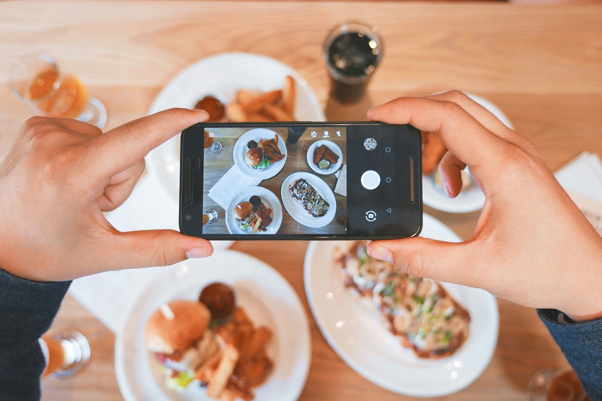 stock image showing a person taking a photo of food