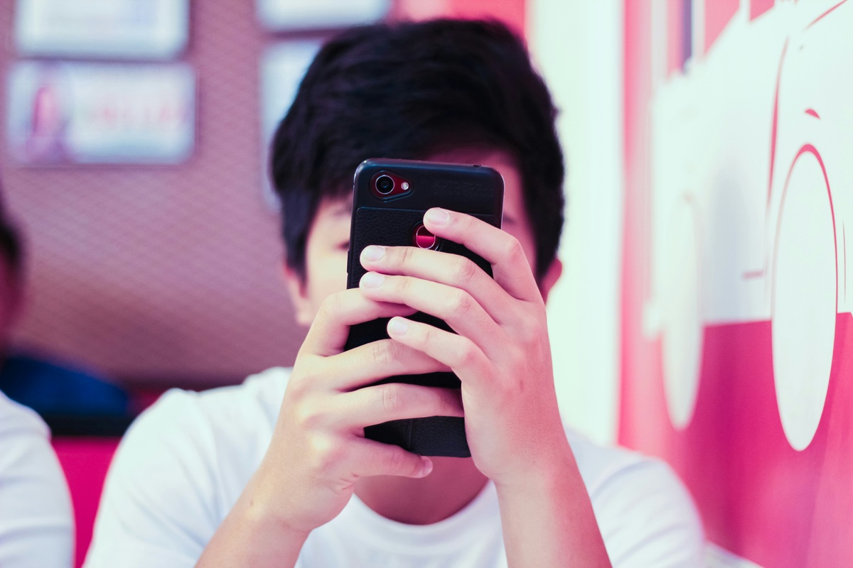 photo of a young person holding a smartphone