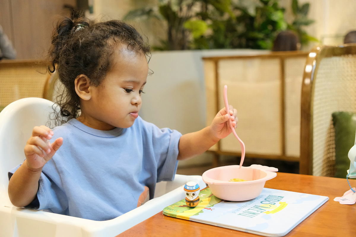 stock photo of a young girl eating from a bowl