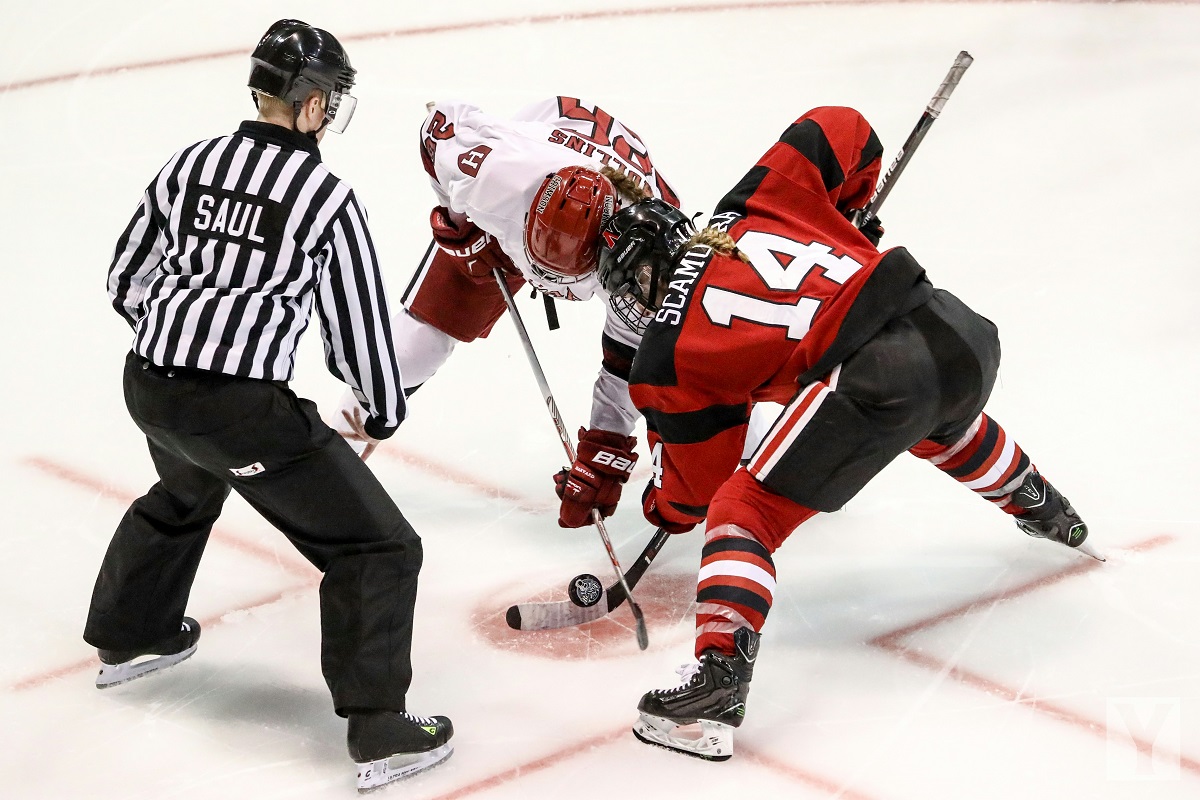 image of women hockey players at a face off